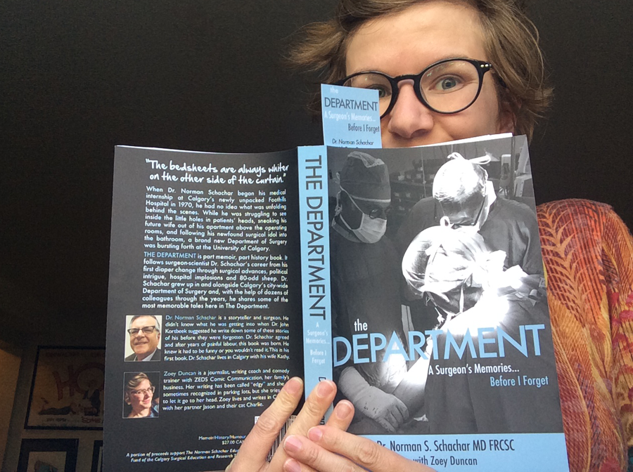 Zoey Duncan holds a copy of her co-authored book, The Department